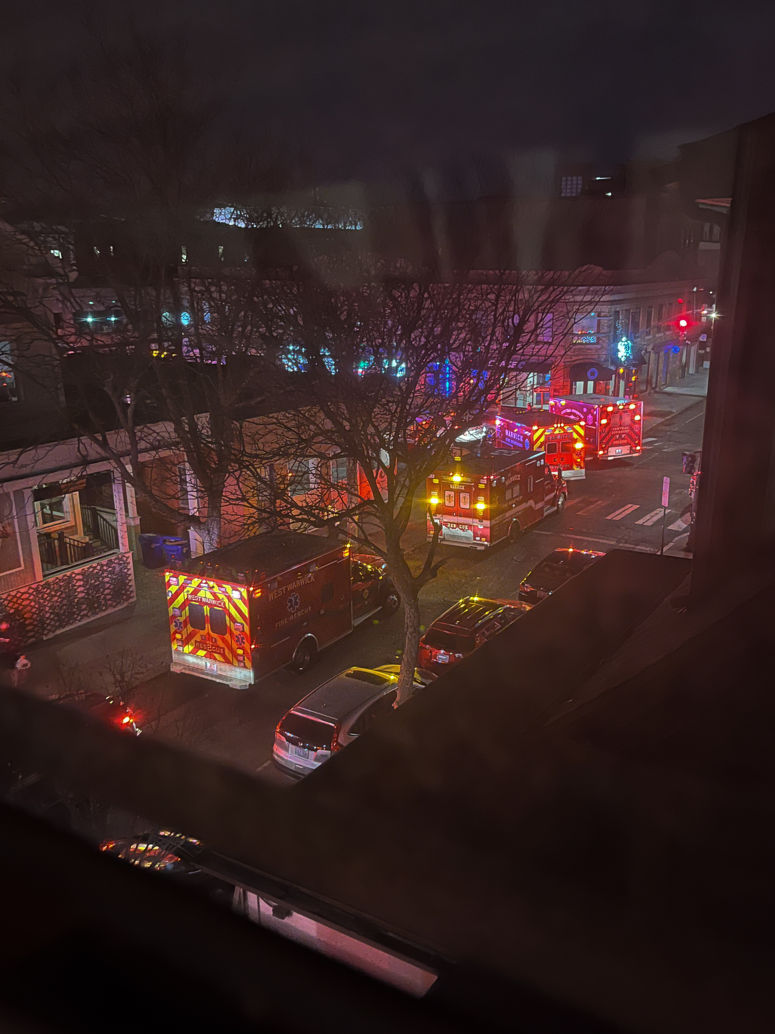 Photo of four ambulances parked on Thayer Street at the intersection of Angell Street.