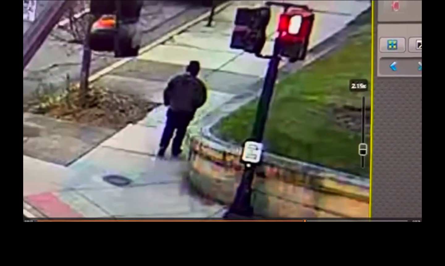 Photo of a man in dark clothing standing at the intersection of Hope Street and Waterman Street.