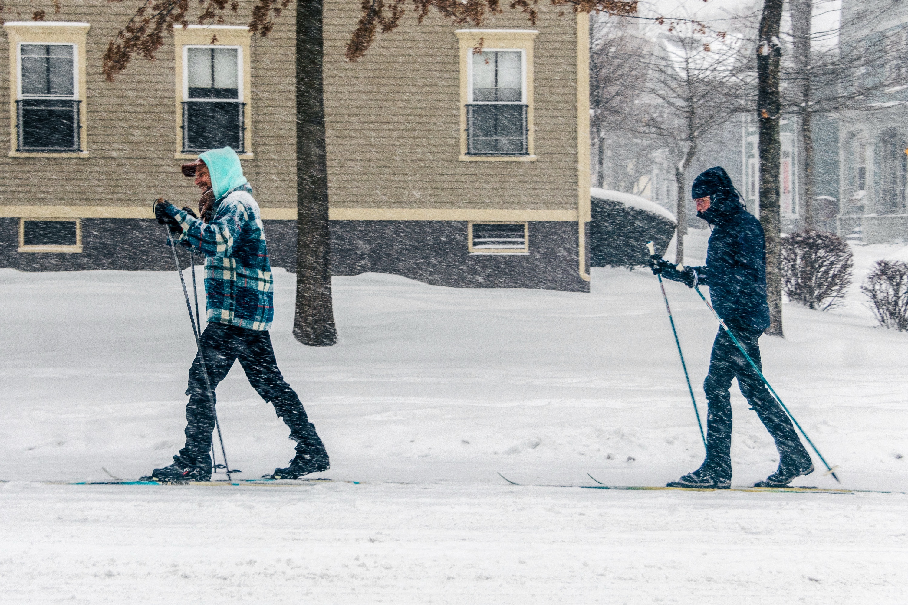 Photo of two people cross country skiing in the winter.