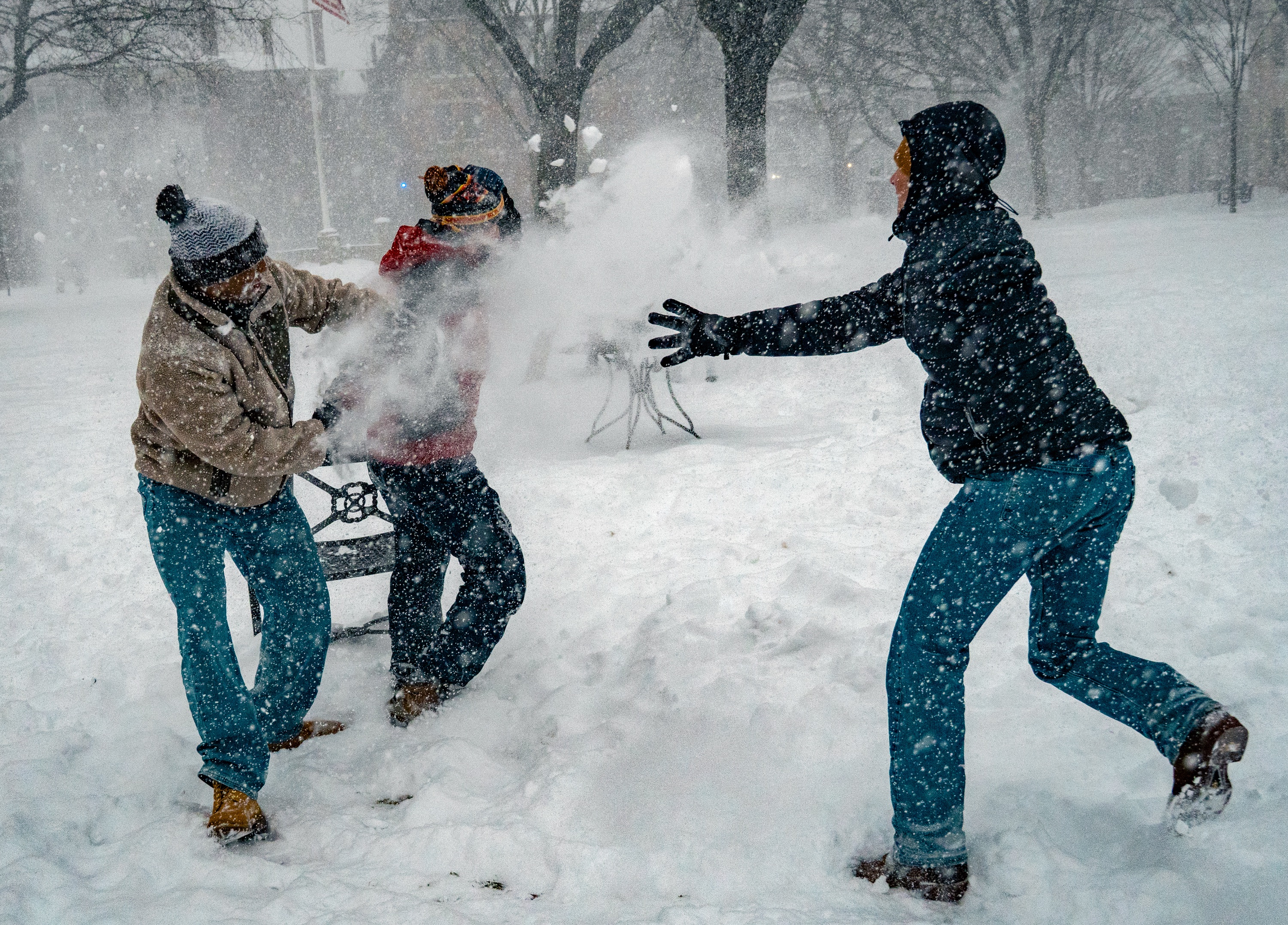 Photo of students tossing a flurry of snow at one another.