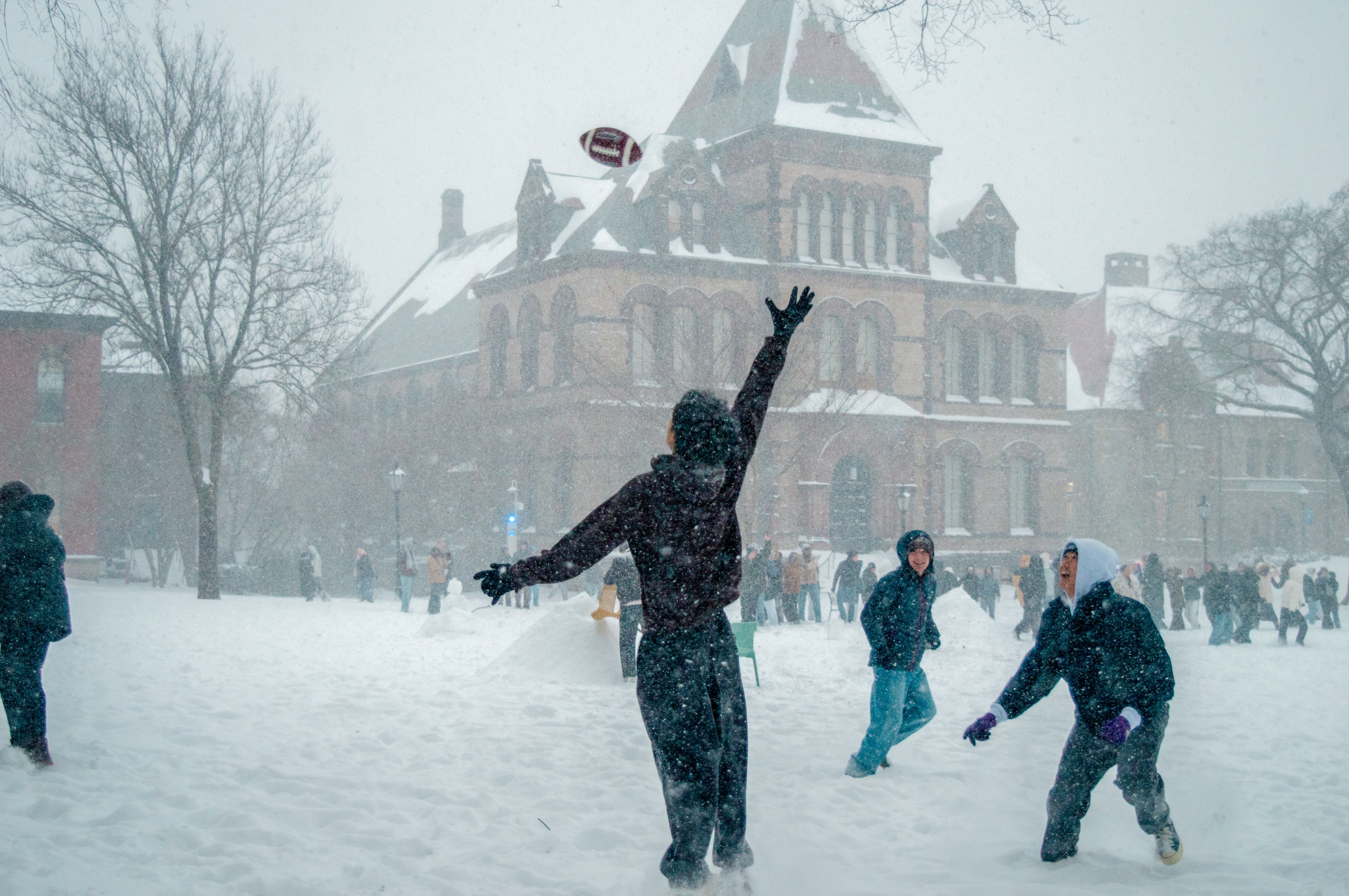 Photo of student throwing football in the snow.